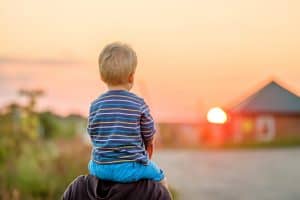 Father and son outdoor portrait in sunset sunlight